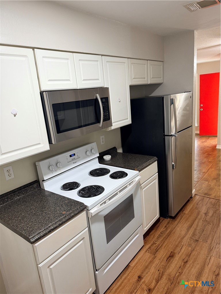a kitchen with a stove microwave and refrigerator