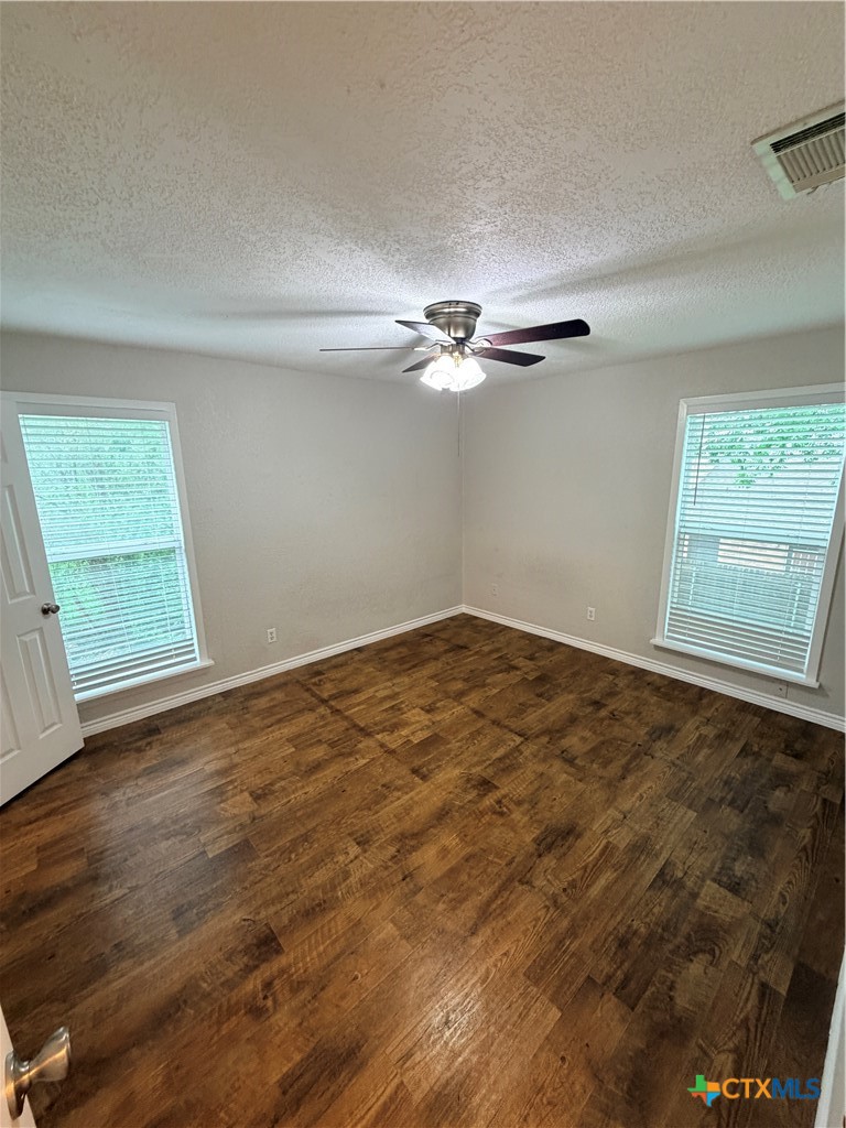 208 Uhland Road, Unit 3 San Marcos, TX 78666 - Photo 11 of 12 wooden floor in an empty room with a window