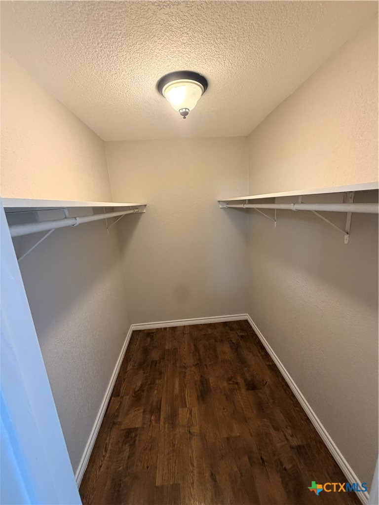 208 Uhland Road, Unit 3 San Marcos, TX 78666 - Photo 12 of 12 a view of a room with wooden floor and white walls