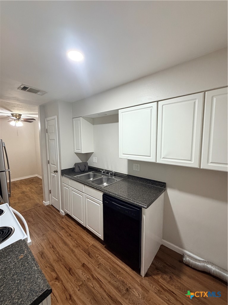 208 Uhland Road, Unit 3 San Marcos, TX 78666 - Photo 2 of 12 a kitchen with granite countertop cabinets stainless steel appliances and a sink