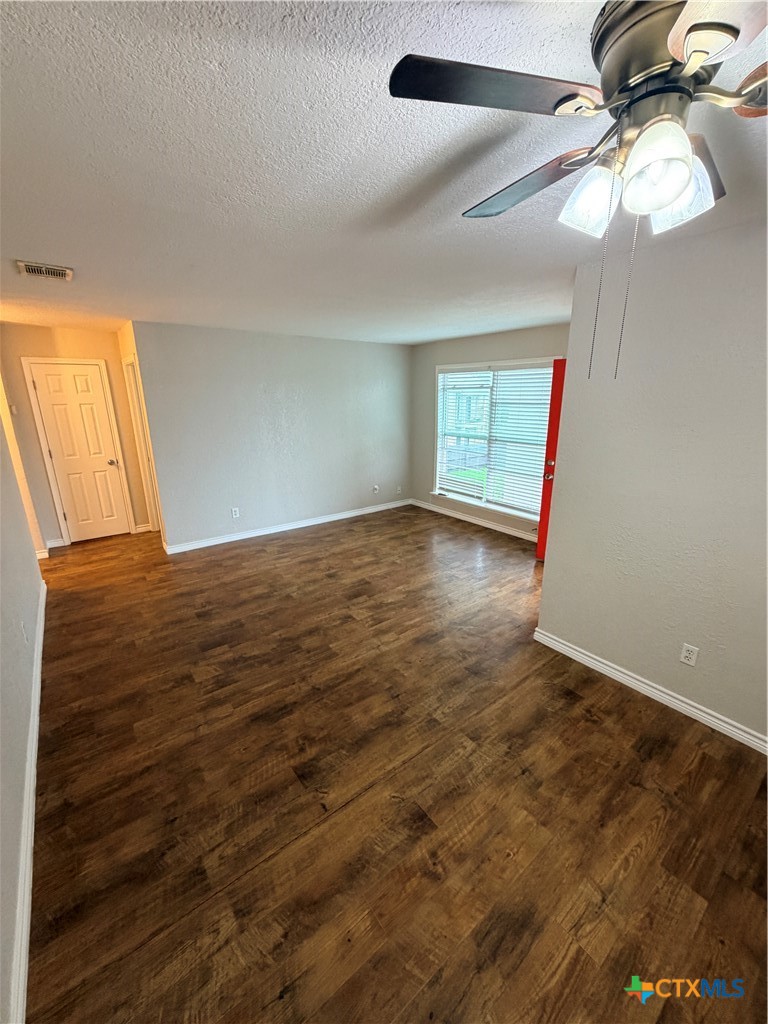 208 Uhland Road, Unit 3 San Marcos, TX 78666 - Photo 4 of 12 wooden floor in an empty room with a window