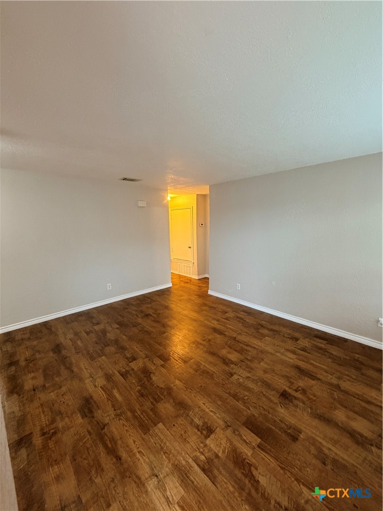 208 Uhland Road, Unit 3 San Marcos, TX 78666 - Photo 5 of 12 a view of empty room with wooden floor