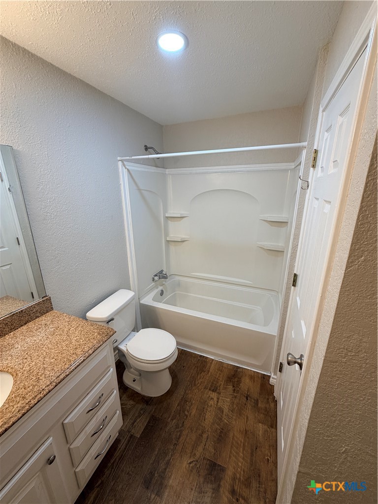 208 Uhland Road, Unit 3 San Marcos, TX 78666 - Photo 10 of 12 a bathroom with a granite countertop sink toilet and shower