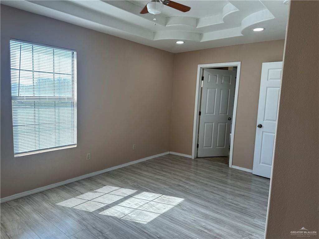 25063 Jesus Flores Road Monte Alto, TX 78538 - Photo 17 of 23 an empty room with wooden floor and windows