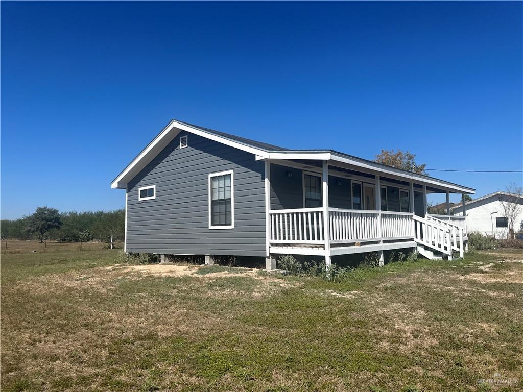 25063 Jesus Flores Road Monte Alto, TX 78538 - Photo 2 of 23 a front of house with a yard