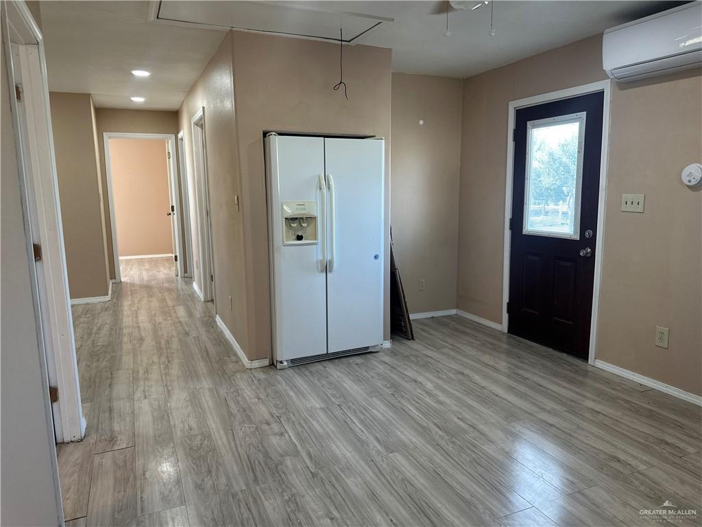 25063 Jesus Flores Road Monte Alto, TX 78538 - Photo 9 of 23 a view of a hallway with wooden floor
