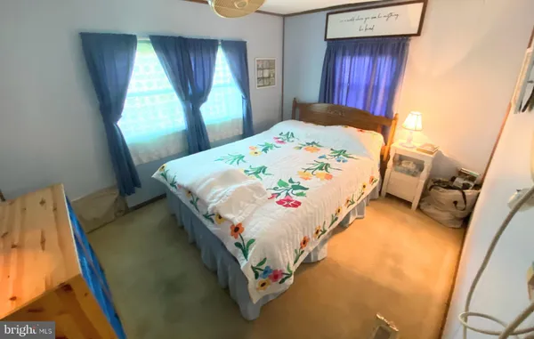 a bed sitting in a bedroom next to a window
