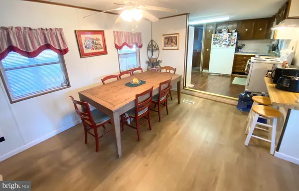 a living room with furniture a flat screen tv and a table
