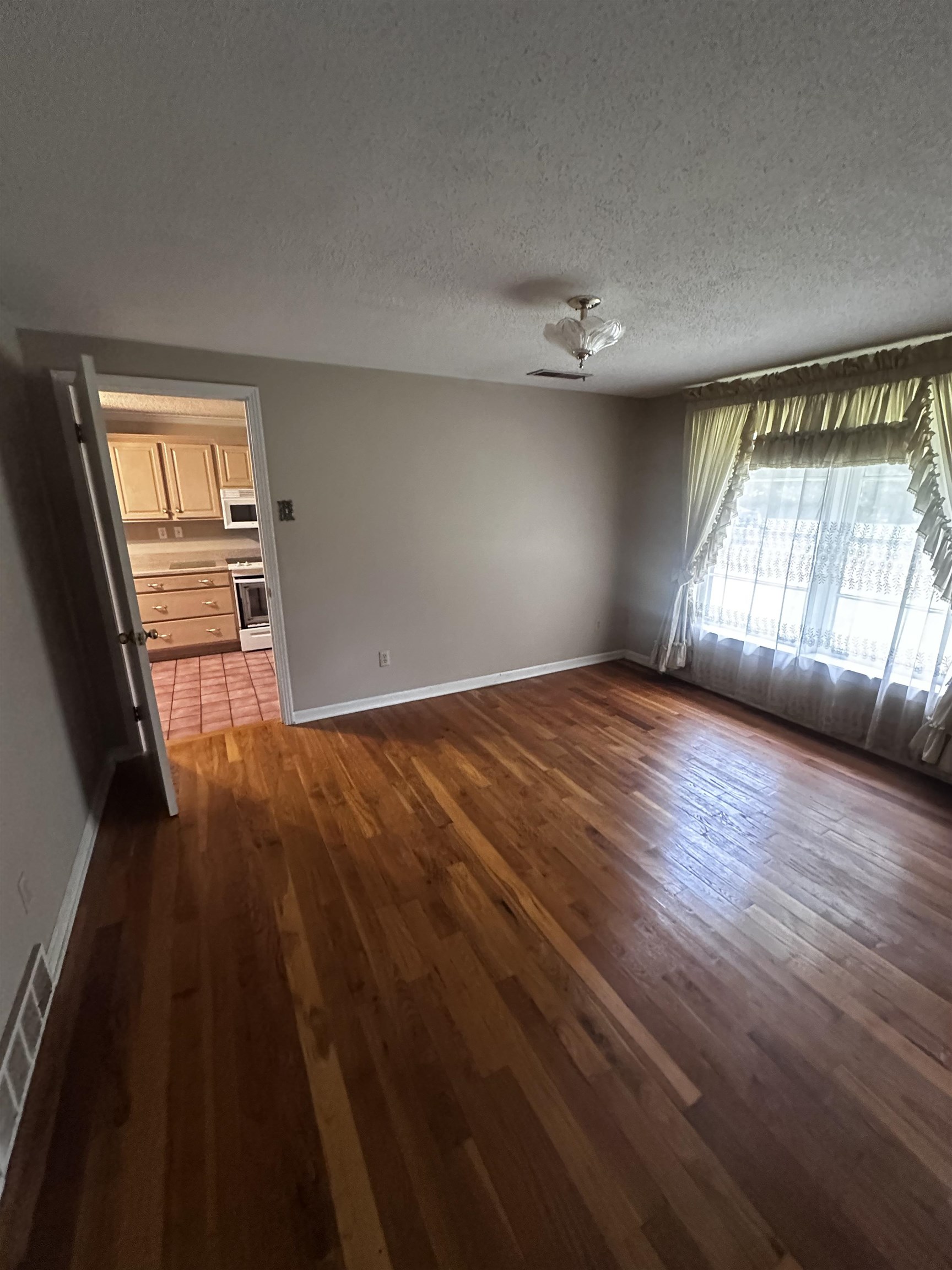 1865 Bartlett Road Memphis, TN 38134 - Photo 21 of 26 wooden floor in an empty room with a window
