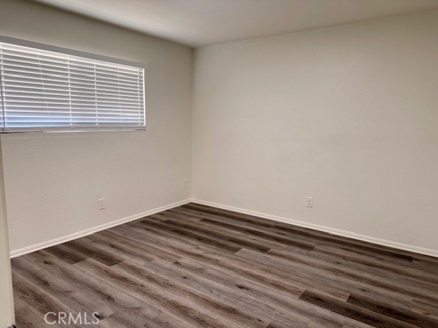 73740 Santa Rosa Way, Unit E Palm Desert, CA 92260 - Photo 11 of 15 a view of empty room with wooden floor