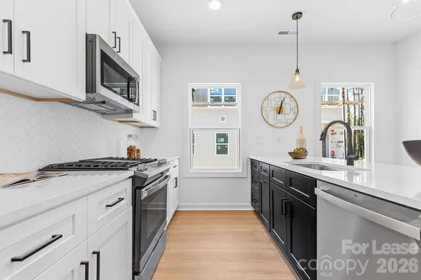 a kitchen with stainless steel appliances granite countertop a stove and a sink