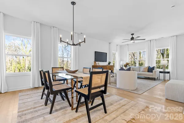 a view of a dining room with furniture window and wooden floor