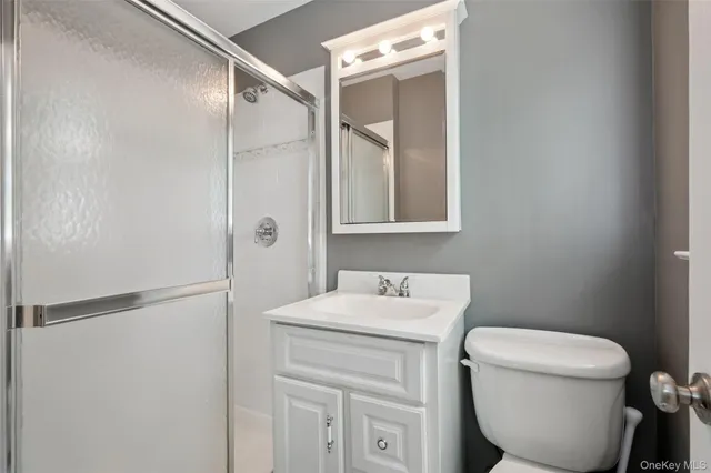 a bathroom with a toilet sink and a mirror