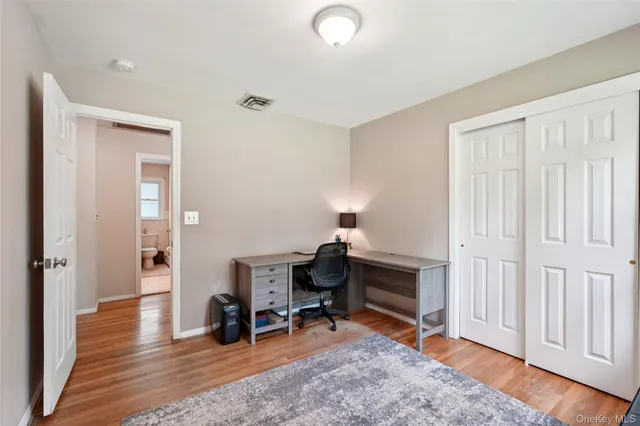 a view of a room with wooden floor and furniture