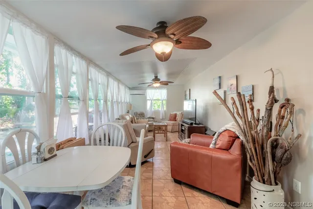 a living room with furniture a large window and a chandelier