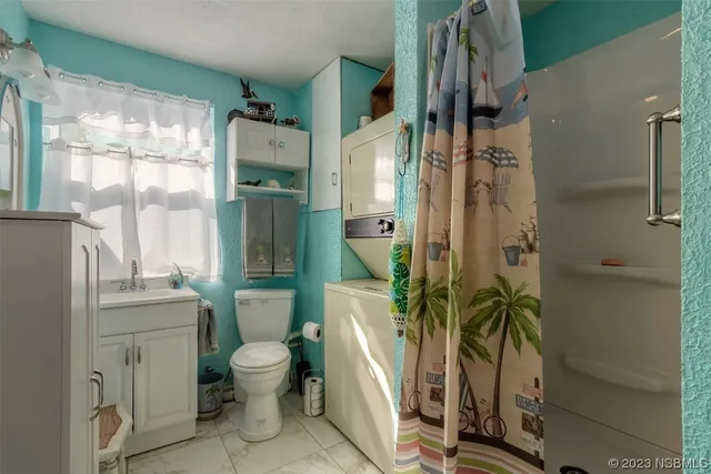 a bathroom with a toilet a sink and shower