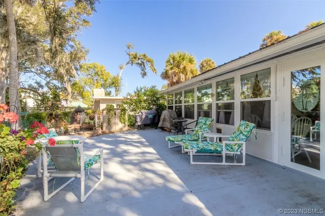 a view of a patio with table and chairs and potted plants