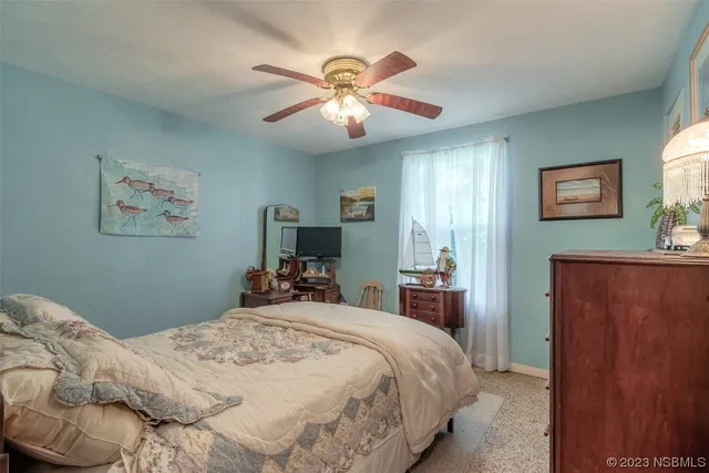 a bedroom with bed and a chandelier