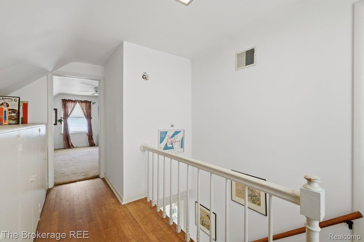 613 East Atherton Road Flint, MI 48507 - Photo 20 of 42 Wood-finish flooring leading to a carpeted room