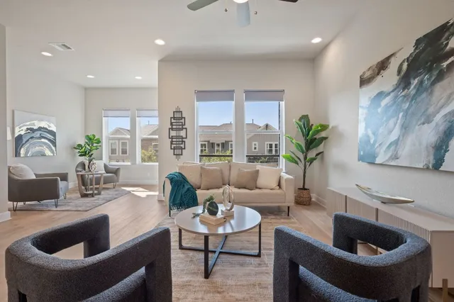 a living room with furniture and a potted plant