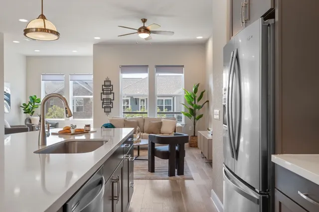 a kitchen with a refrigerator a sink and cabinets