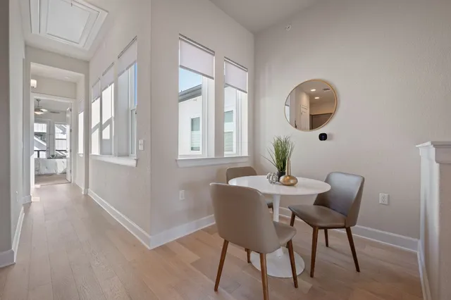a view of a dining room with furniture and wooden floor