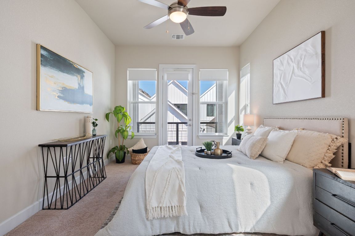 2510 Doc Reeves Street Austin, TX 78723 - Photo 21 of 39 a bedroom with a bed and a chandelier