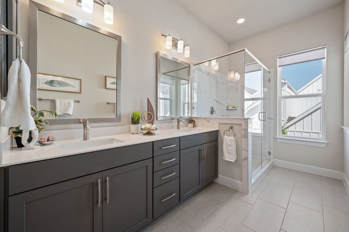 2510 Doc Reeves Street Austin, TX 78723 - Photo 23 of 39 a spacious bathroom with a double vanity sink a mirror and a shower