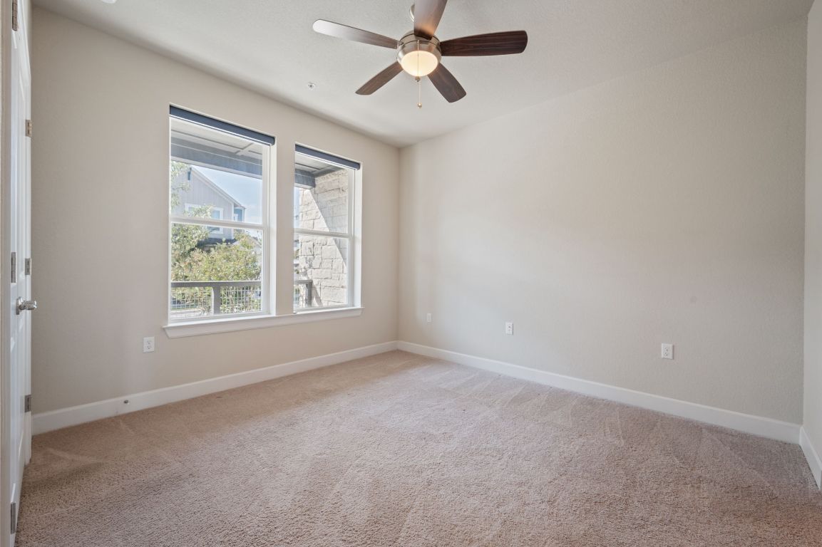 2510 Doc Reeves Street Austin, TX 78723 - Photo 28 of 39 en empty room with windows and ceiling fan