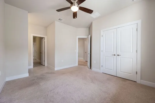 a view of empty room with ceiling fan