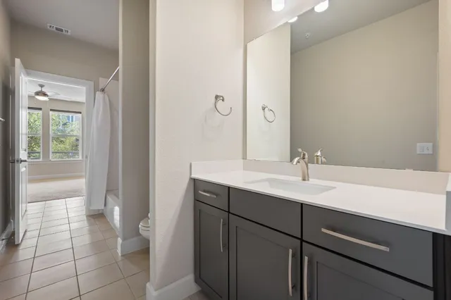 a bathroom with a sink a toilet and a mirror
