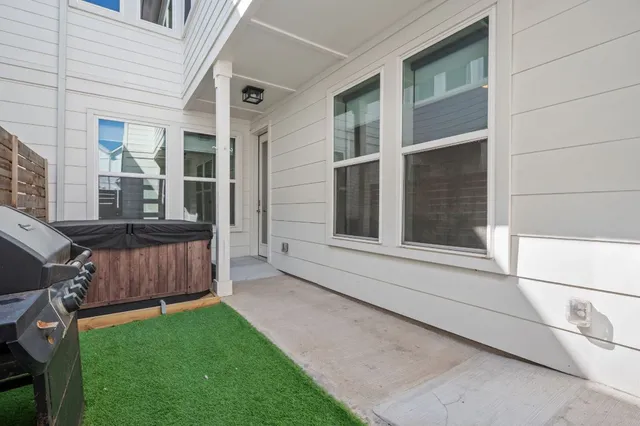 a view of a house with a yard and sitting area