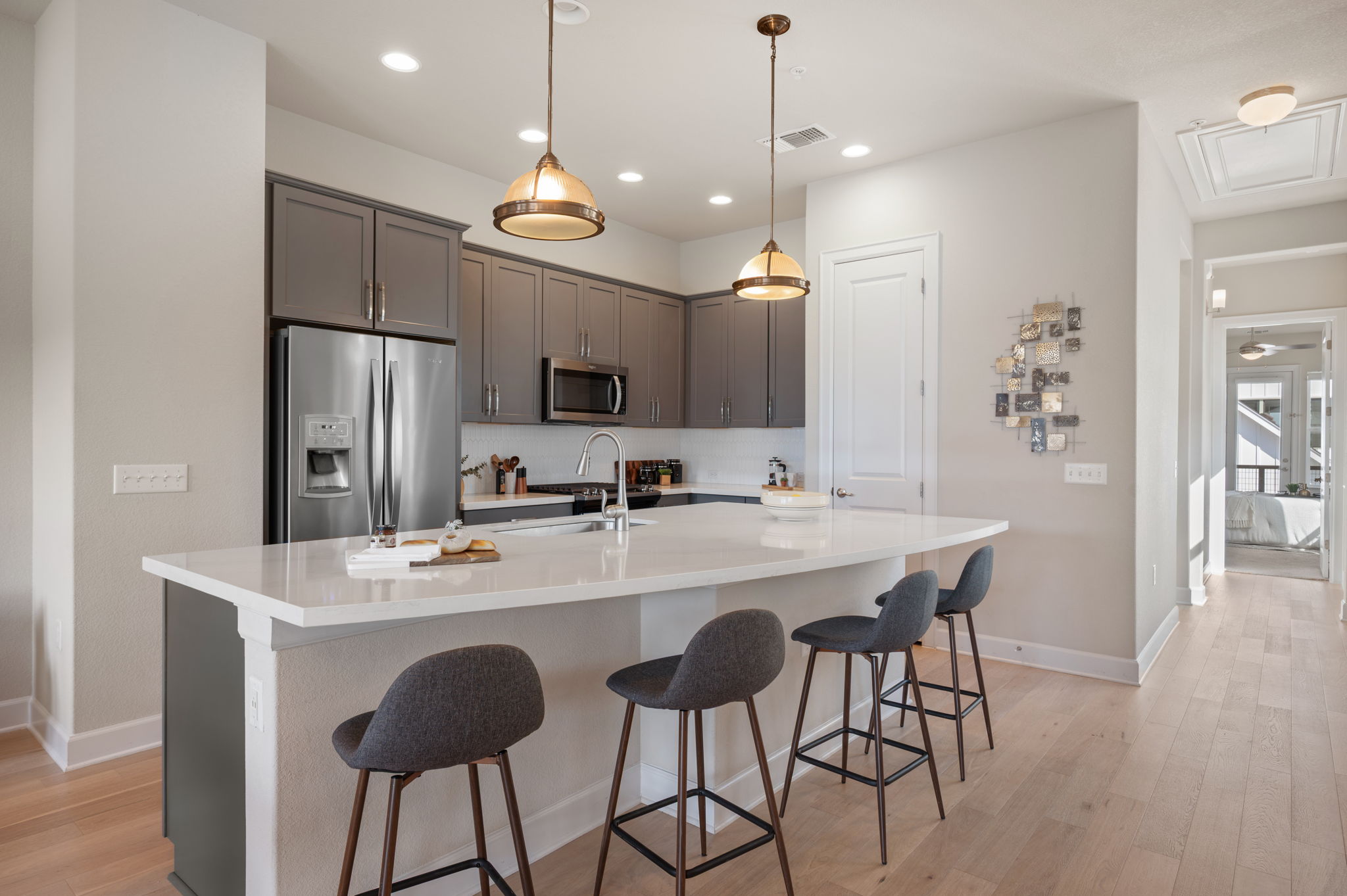 2510 Doc Reeves Street Austin, TX 78723 - Photo 4 of 39 a kitchen with stainless steel appliances a dining table chairs refrigerator and microwave