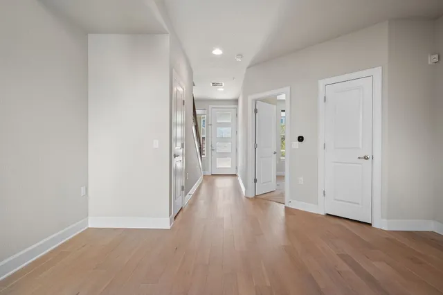 a view of a hallway with wooden floor