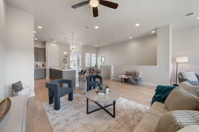 a living room with furniture and a chandelier