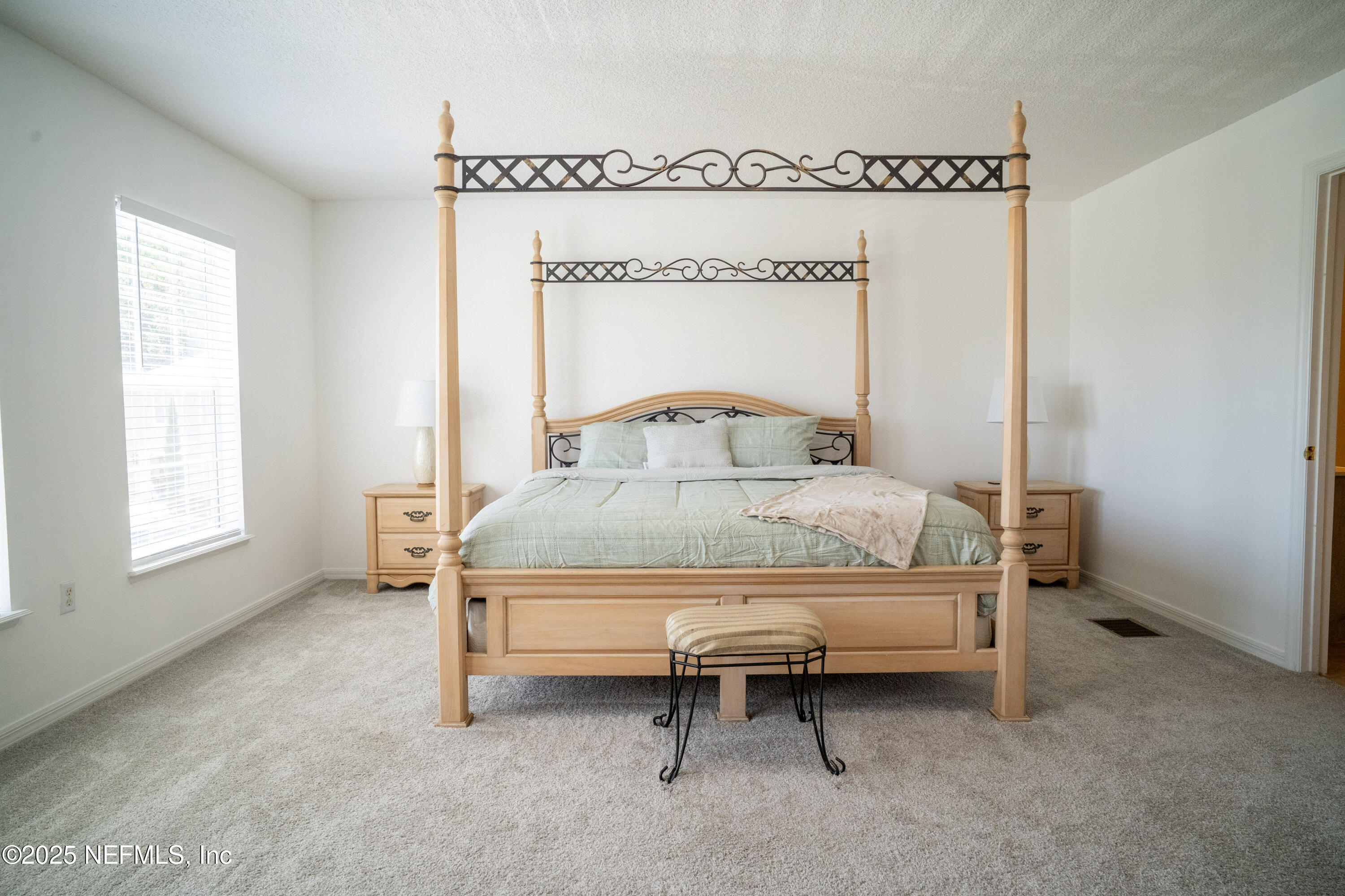 76391 Longleaf Loop Yulee, FL 32097 - Photo 29 of 58 a bedroom with a bed and a window