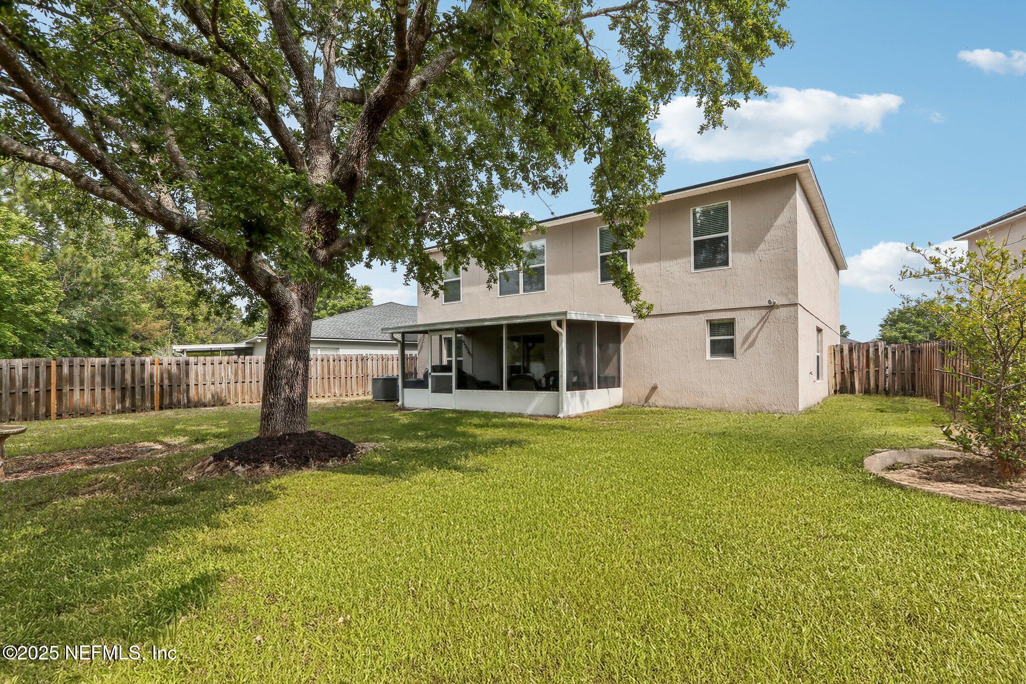 76391 Longleaf Loop Yulee, FL 32097 - Photo 39 of 58 a front view of a house with garden