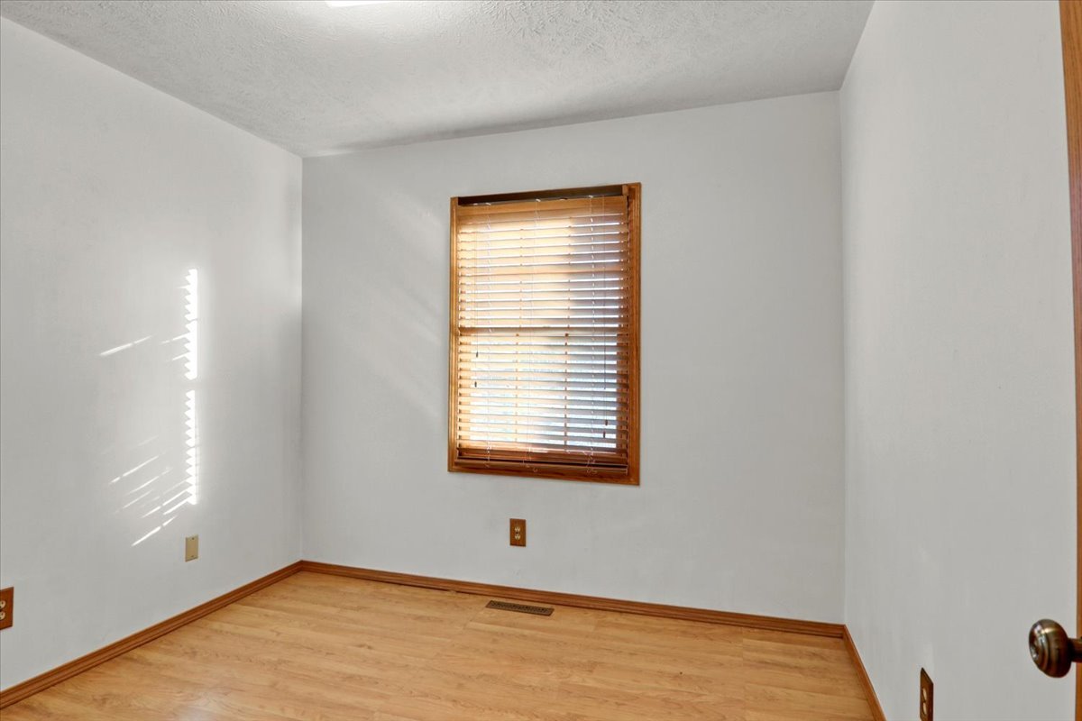 1720 Johnson Drive Normal, IL 61761 - Photo 12 of 23 a view of an empty room with wooden floor and a window