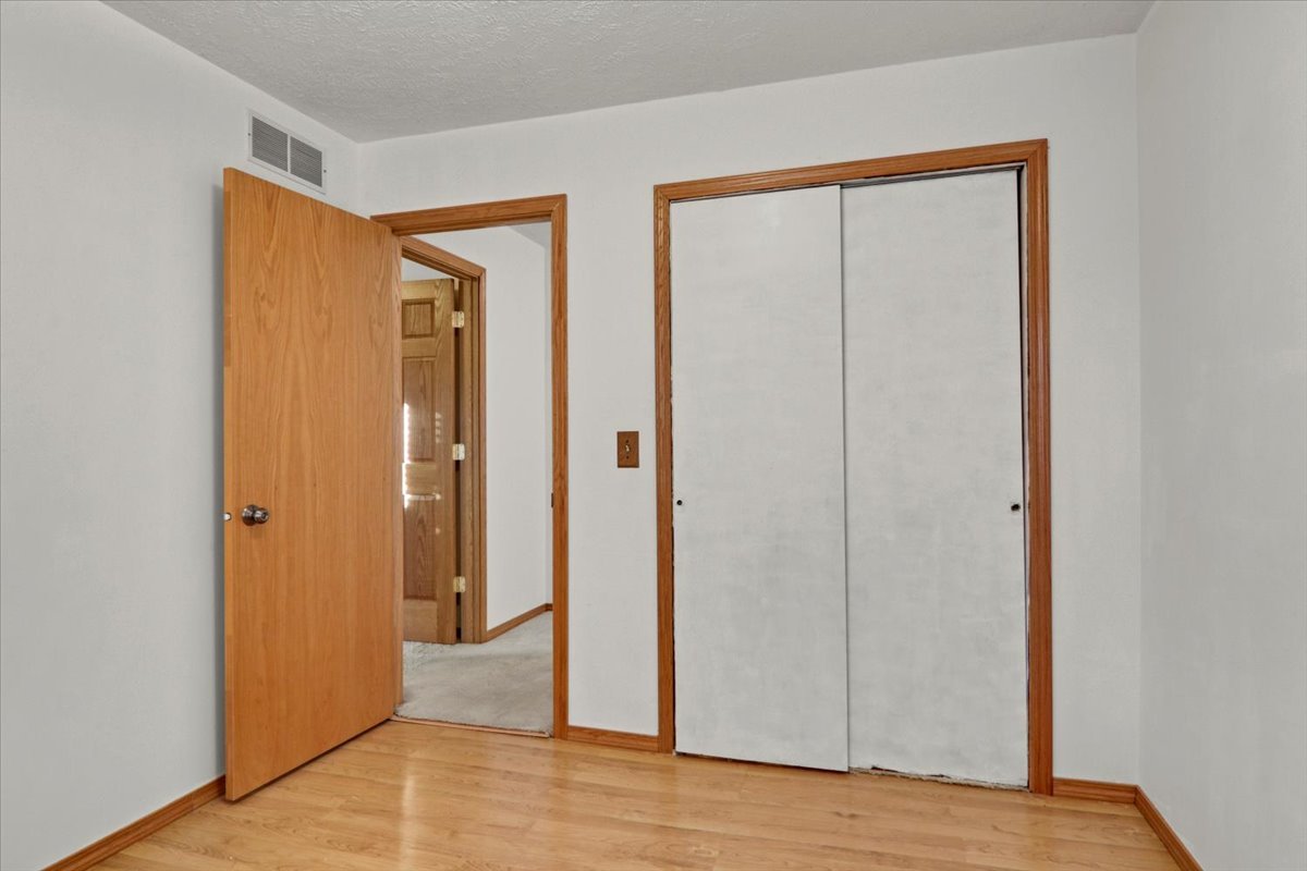 1720 Johnson Drive Normal, IL 61761 - Photo 13 of 23 a view of an empty room with wooden floor and a window