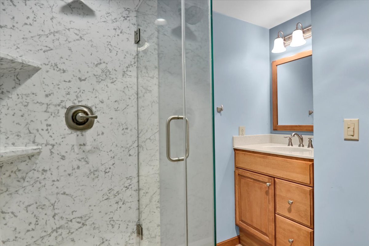 1720 Johnson Drive Normal, IL 61761 - Photo 19 of 23 a bathroom with a granite countertop sink a mirror and shower