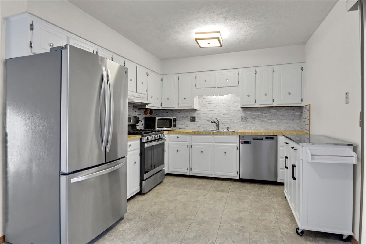 1720 Johnson Drive Normal, IL 61761 - Photo 5 of 23 a kitchen with cabinets and stainless steel appliances