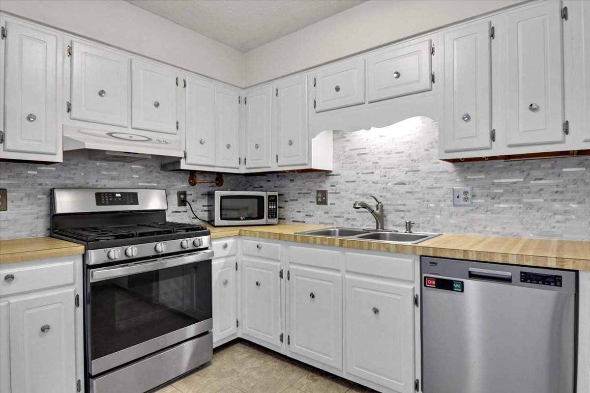 1720 Johnson Drive Normal, IL 61761 - Photo 6 of 23 a kitchen with granite countertop white cabinets and white stove