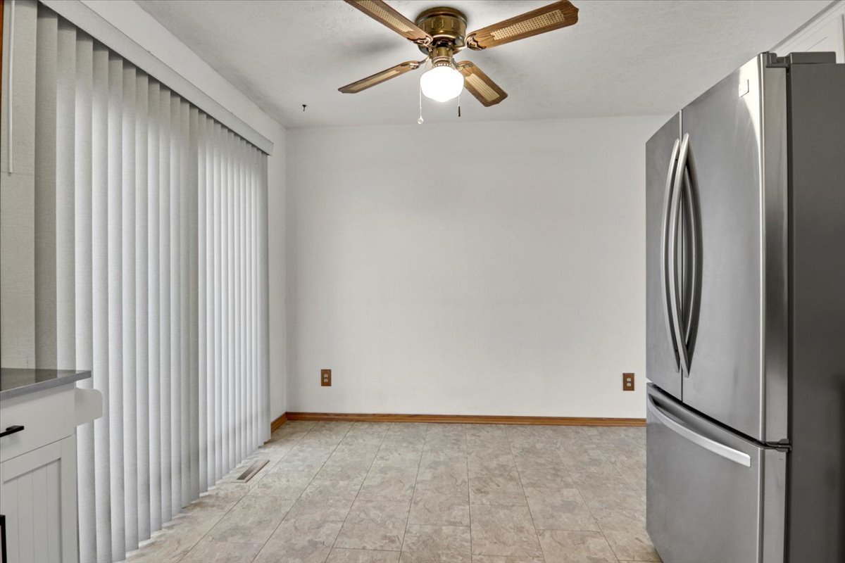 1720 Johnson Drive Normal, IL 61761 - Photo 7 of 23 a view of a kitchen with a refrigerator and ceiling fan