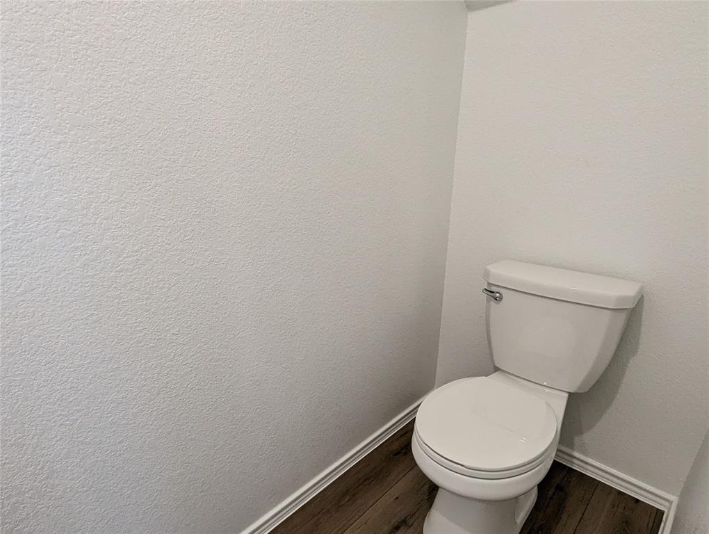 152 Avre Loop Kyle, TX 78640 - Photo 7 of 24 Functional and clean, this restroom features durable wood flooring.