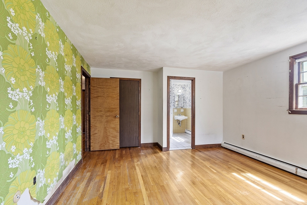 39 Winslow Street Concord, MA 01742 - Photo 12 of 22 wooden floor in an empty room with a window