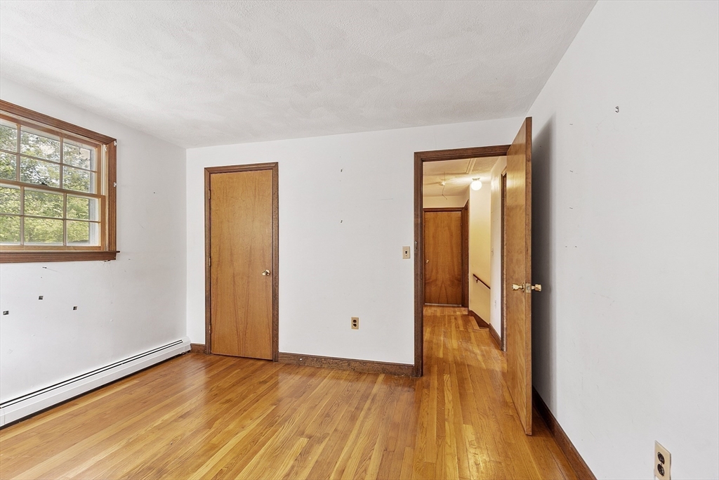 39 Winslow Street Concord, MA 01742 - Photo 13 of 22 an empty room with wooden floor and closet