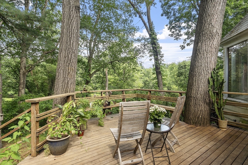 39 Winslow Street Concord, MA 01742 - Photo 7 of 22 a view of a balcony with chairs and wooden floor