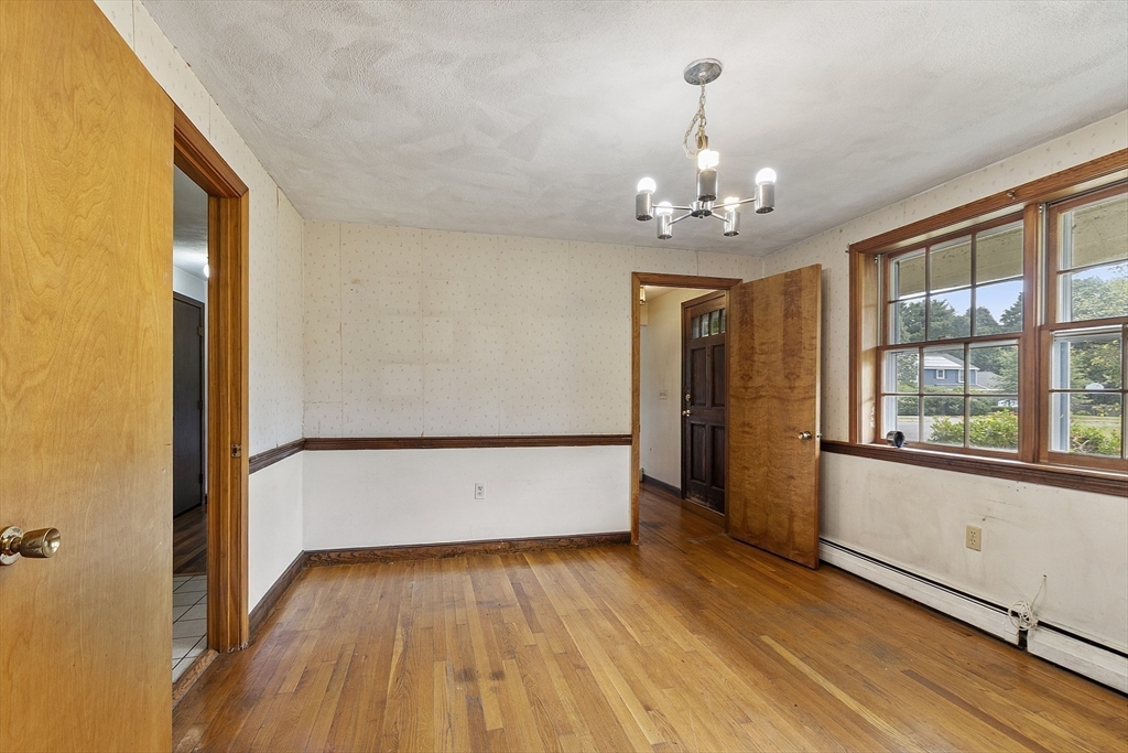 39 Winslow Street Concord, MA 01742 - Photo 9 of 22 wooden floor in an empty room with a window