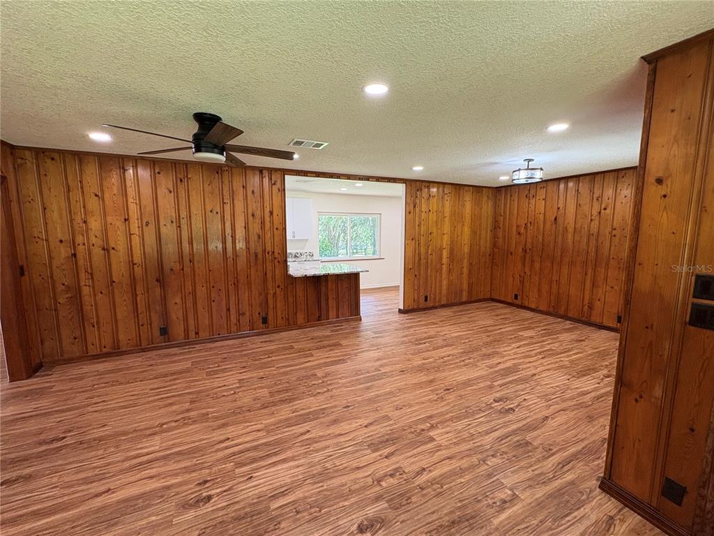 2110 Northwest 100th Street Ocala, FL 34475 - Photo 11 of 44 a view of an empty room with wooden floor and a window