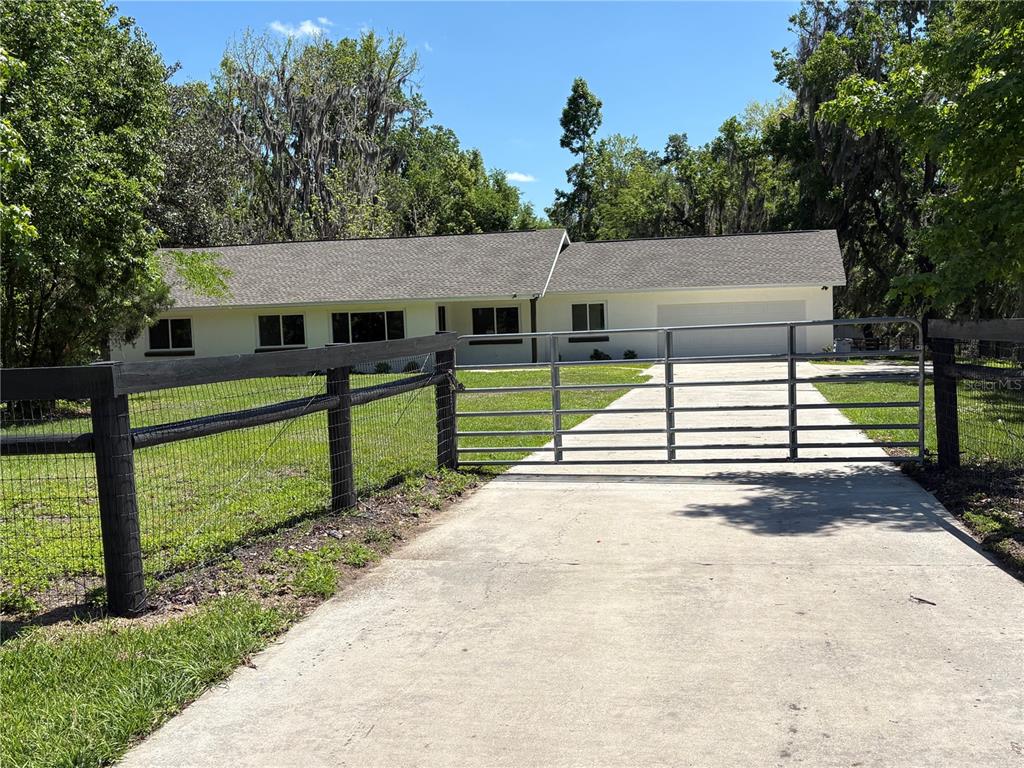 2110 Northwest 100th Street Ocala, FL 34475 - Photo 12 of 44 a view of a house with a yard and a large tree